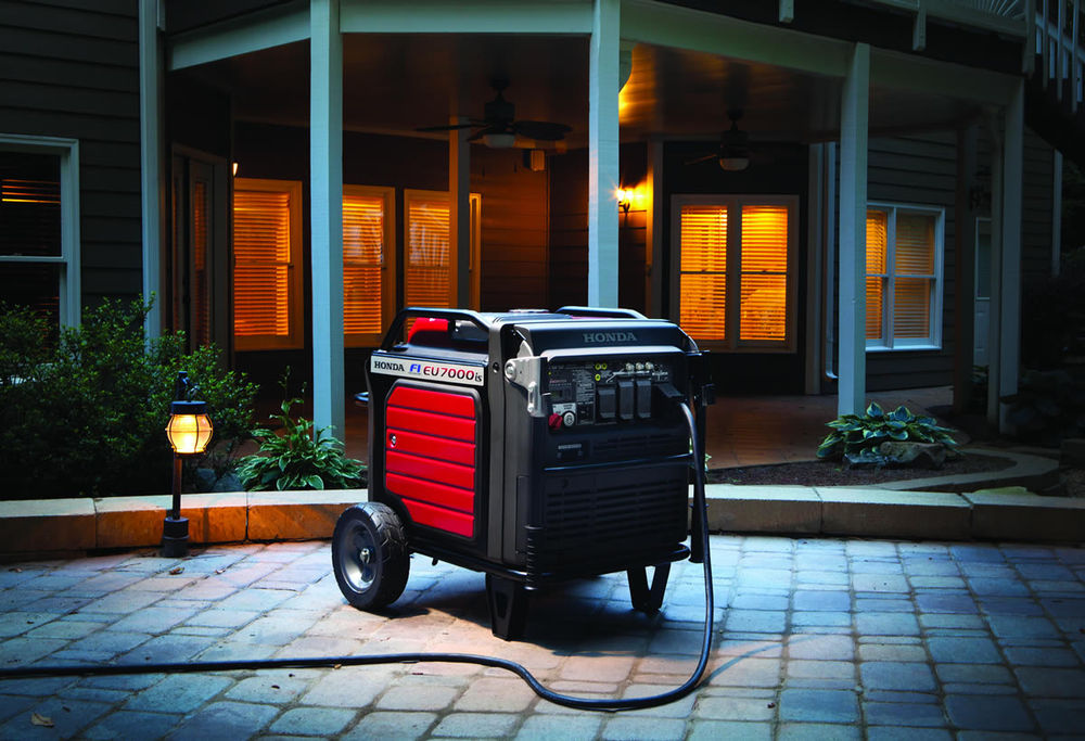 Honda EU7000iS inverter generator supplying power to a house in the evening