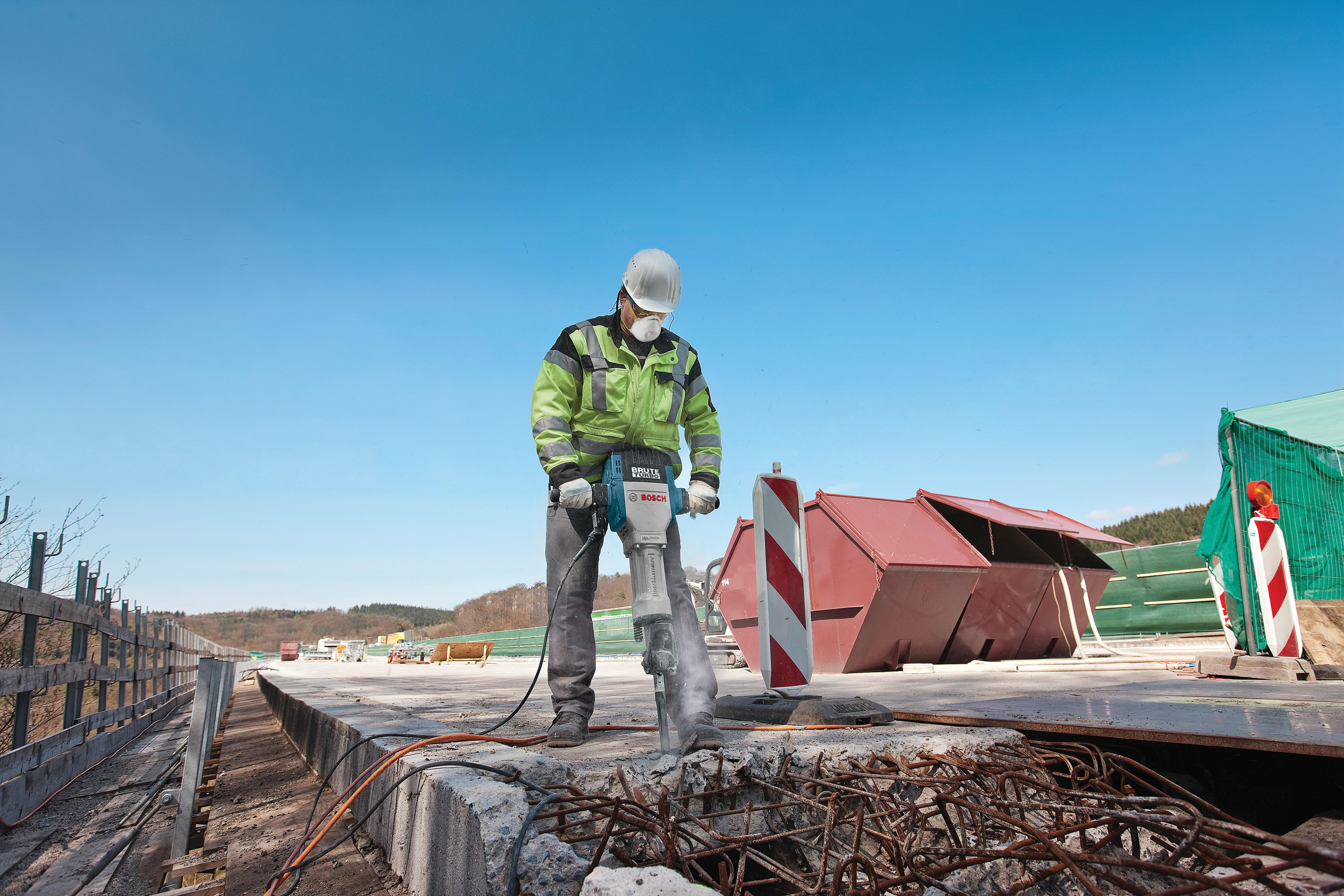 Worker breaking up a bridge deck with the Bosch Brute Turbo breaker hammer