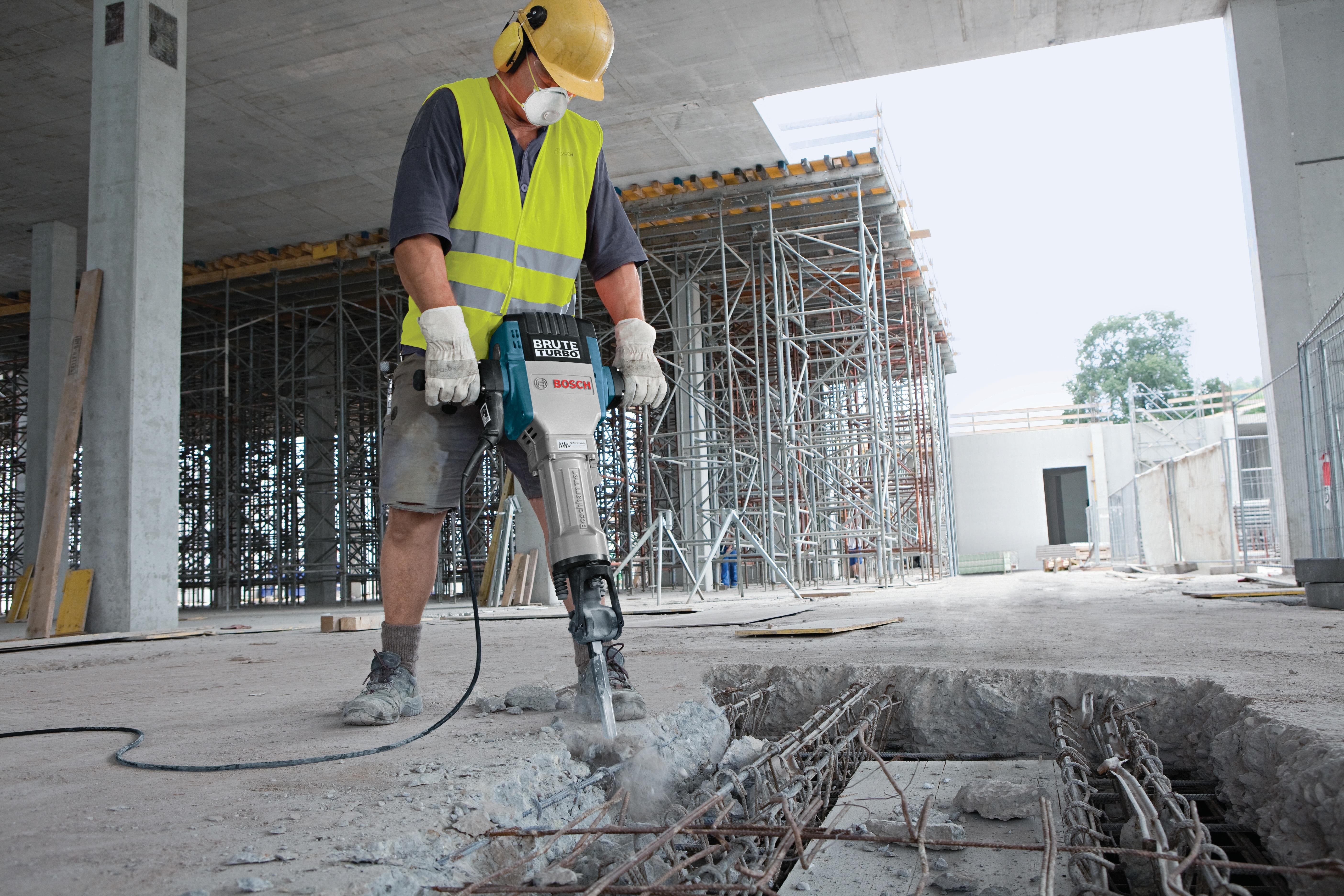 Worker breaking a slab in a parking structure with the Bosch Brute Turbo breaker hammer