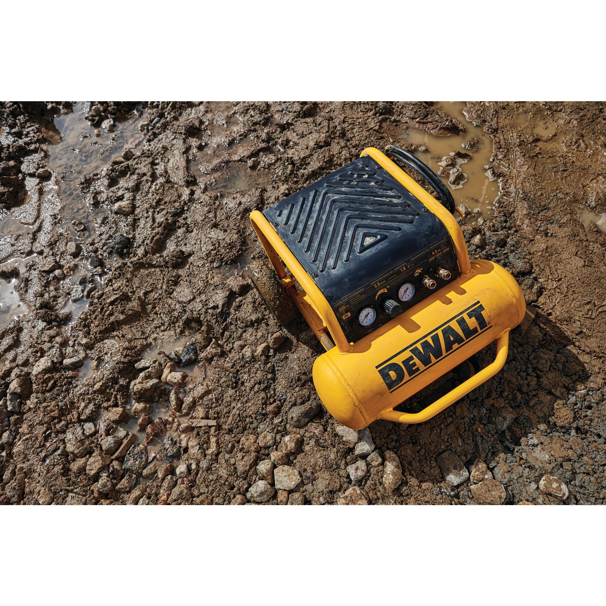 Overhead view of the DeWalt 4.5 gallon compressor standing upright in mud