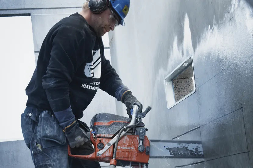Operator cutting a wall opening with the Husqvarna K 970 Chain concrete saw
