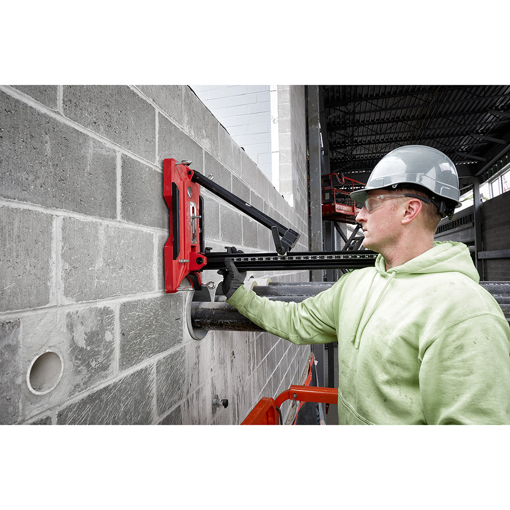 Operator coring a block wall with the MX FUEL core drill mounted on its stand