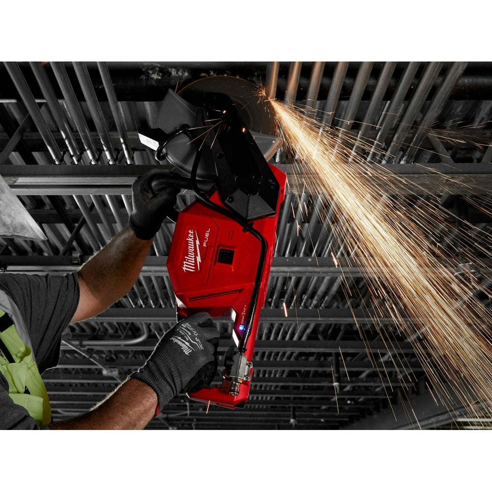 Worker cutting overhead rebar with the M18 FUEL cut-off saw, sparks flying