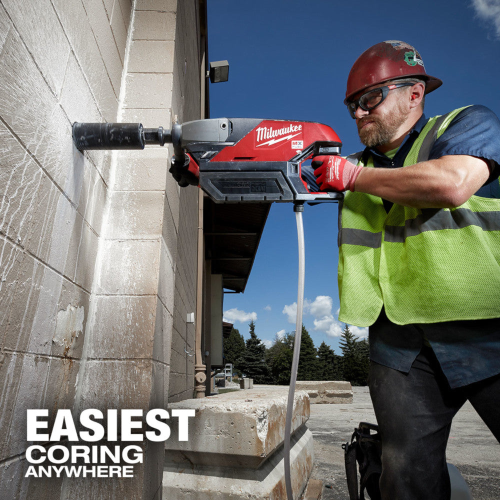Operator coring an exterior stone wall with the MX FUEL handheld core drill