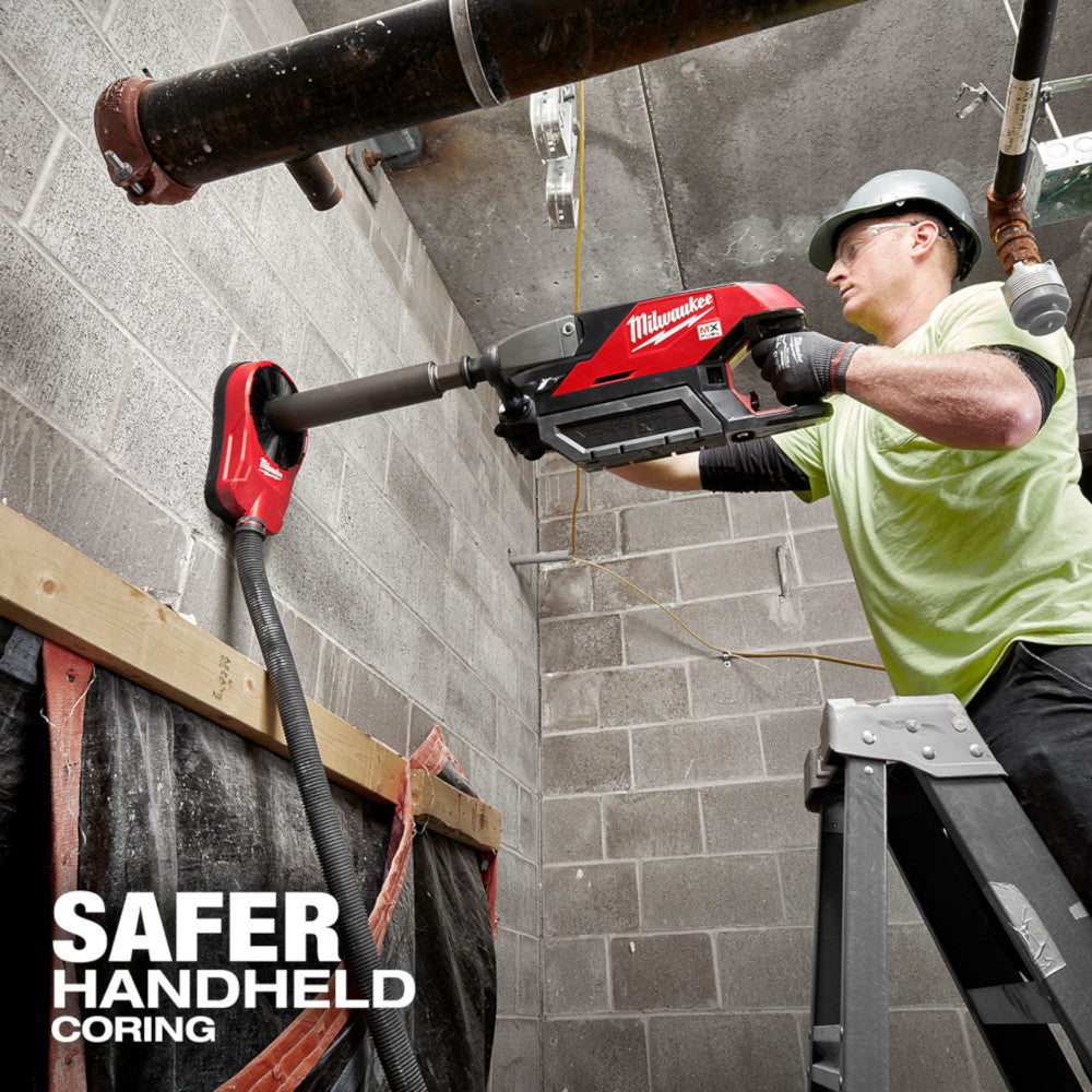 Operator coring overhead through a wall with the MX FUEL handheld core drill, safer handheld coring